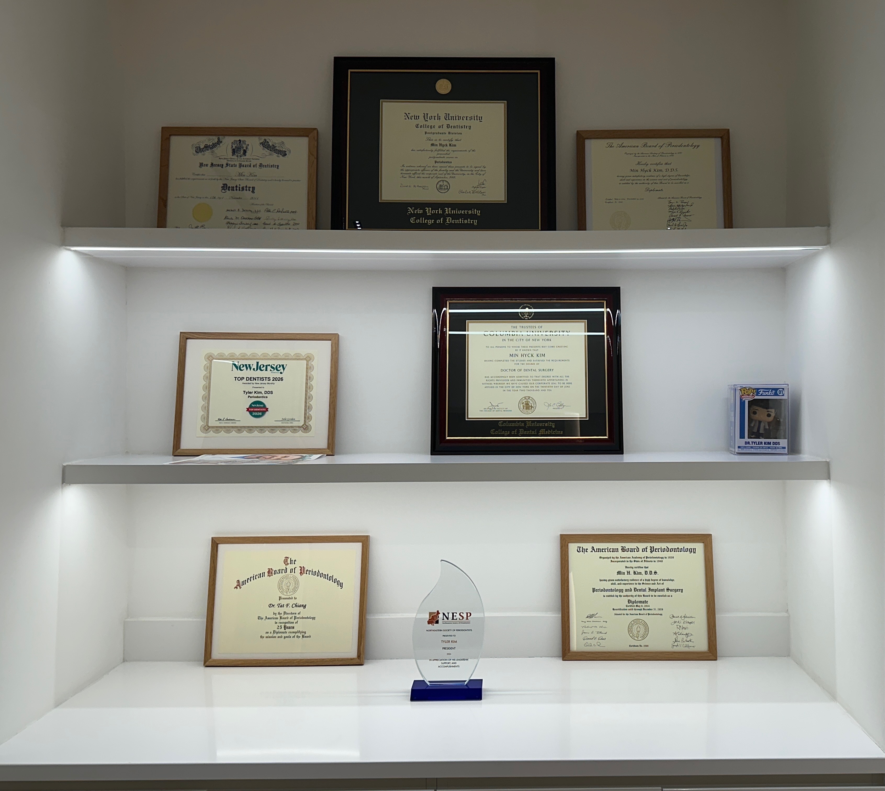 Dr. Kim's credentials and diplomas displayed in the office